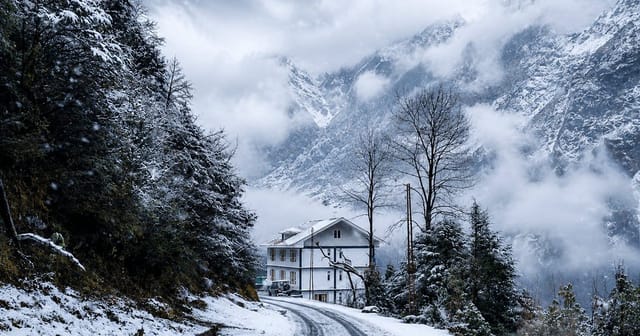 Mist-covered Himalayan peaks above the valley at Lachung, North Sikkim